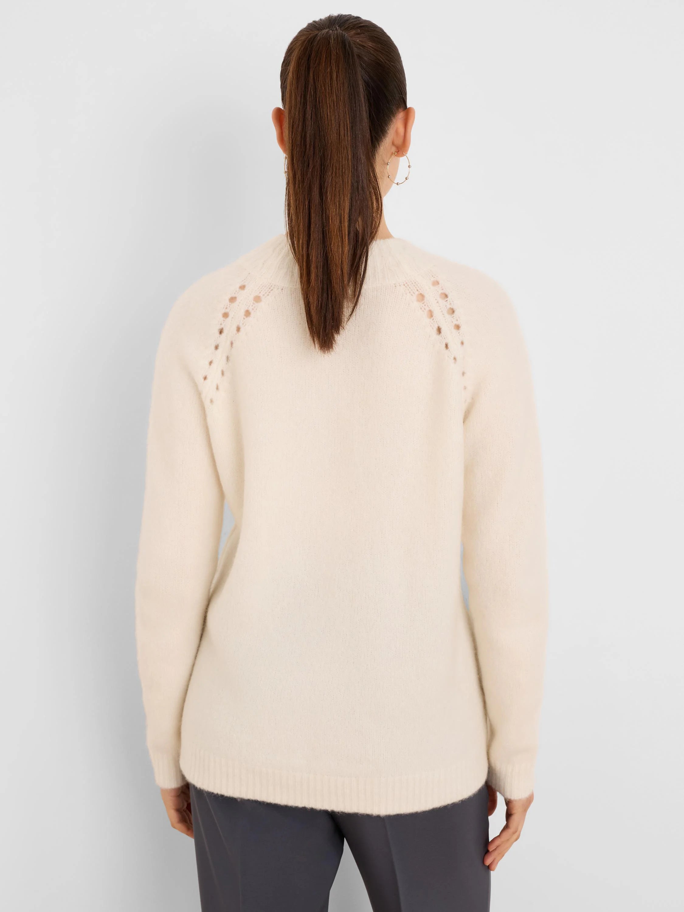 Off-white fuzzy sweater, shown from the back. Features a crew neck and delicate open-knit details along the shoulders.