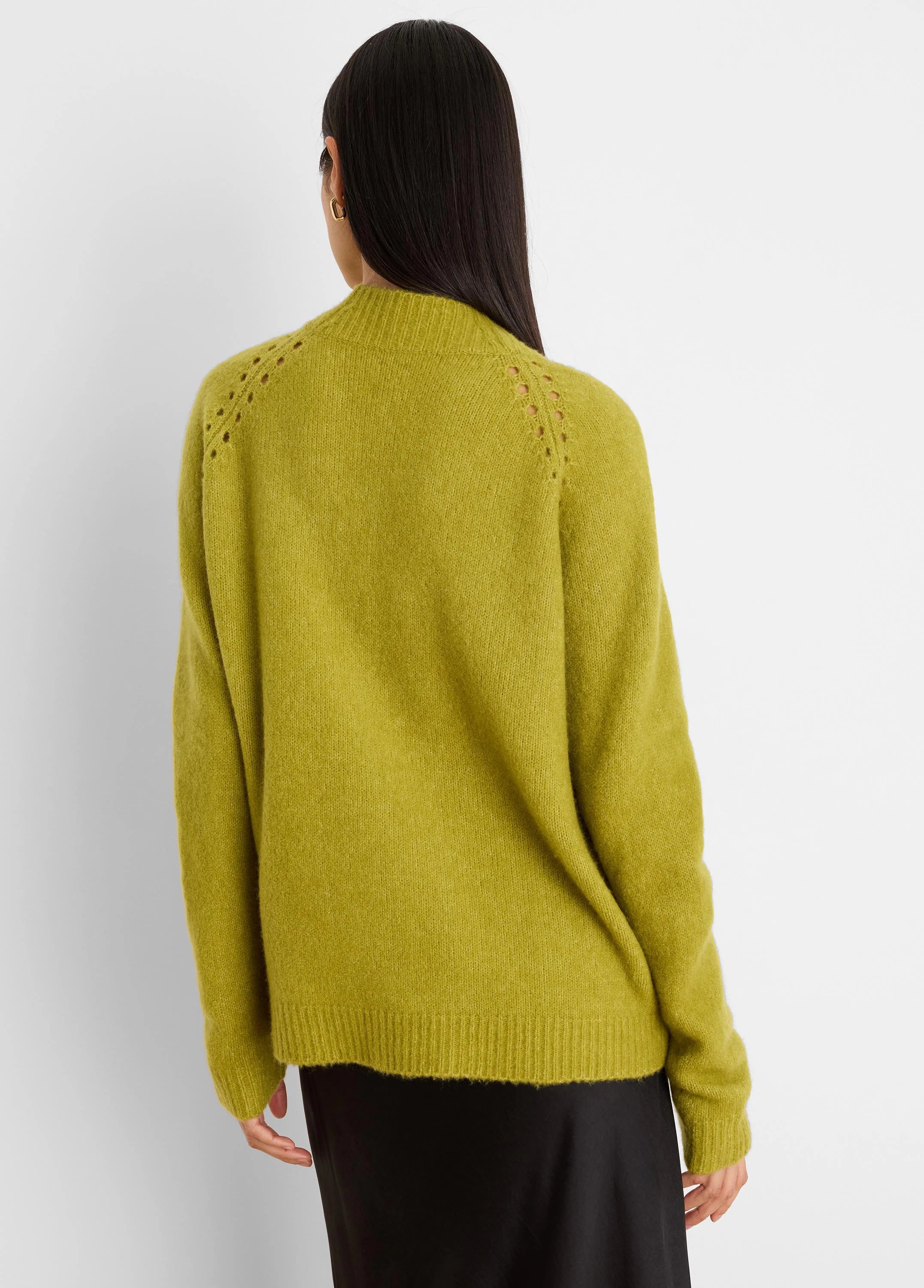 Chartreuse green fuzzy sweater, seen from behind. Features open-knit shoulder details, ribbed cuffs and hem.