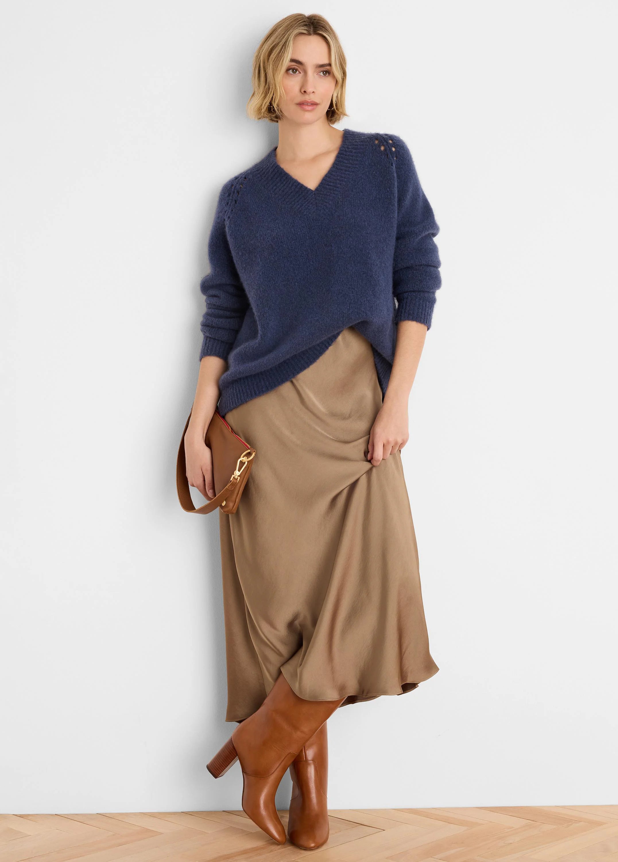 Navy V-neck sweater, soft, fuzzy knit, with small eyelets on shoulders.