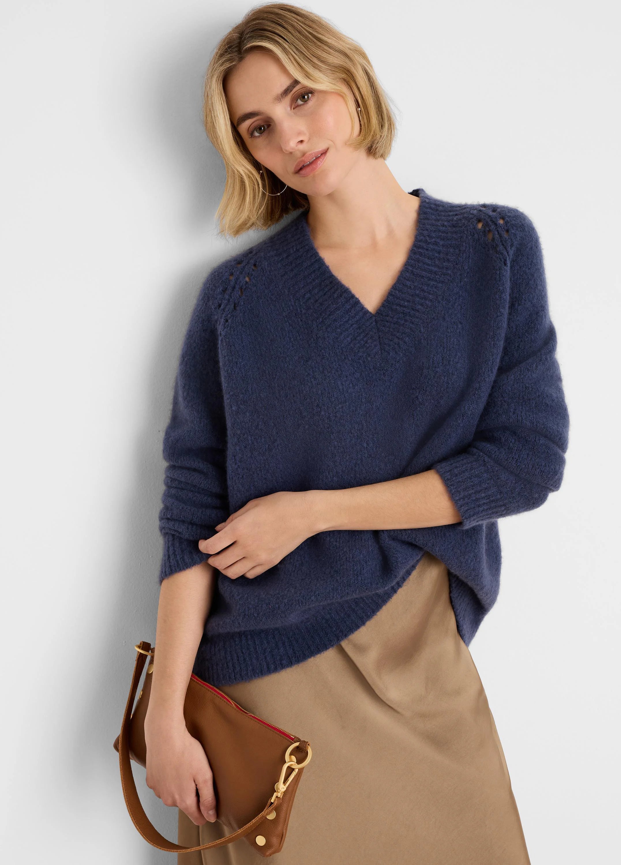 Fuzzy deep blue V-neck sweater with openwork shoulder details.