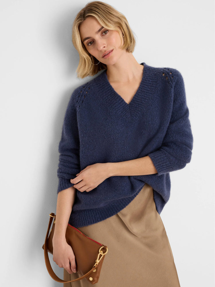 Fuzzy deep blue V-neck sweater with openwork shoulder details.