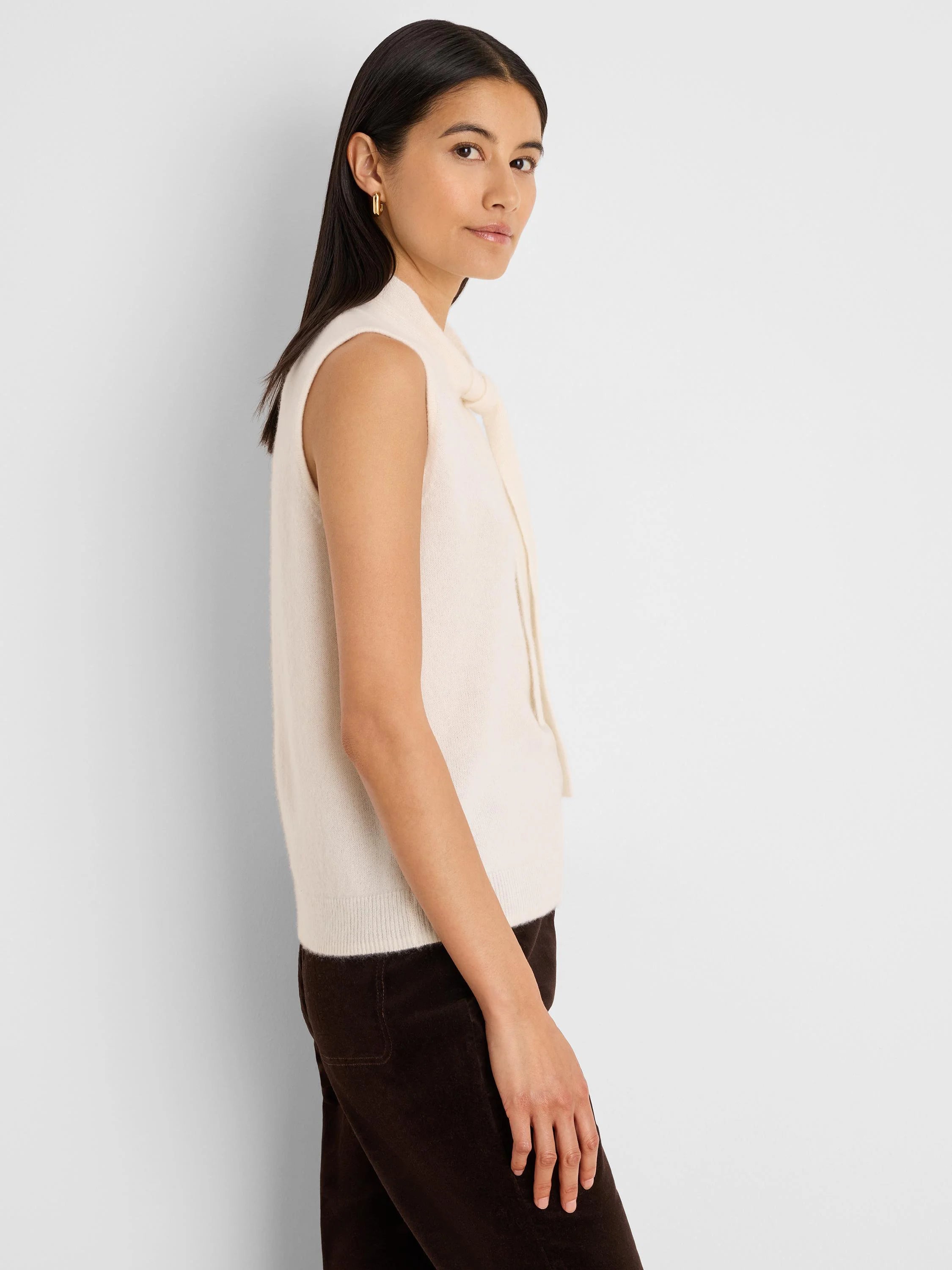 Cream cashmere blend sleeveless tank with a high neckline and bow ties.
