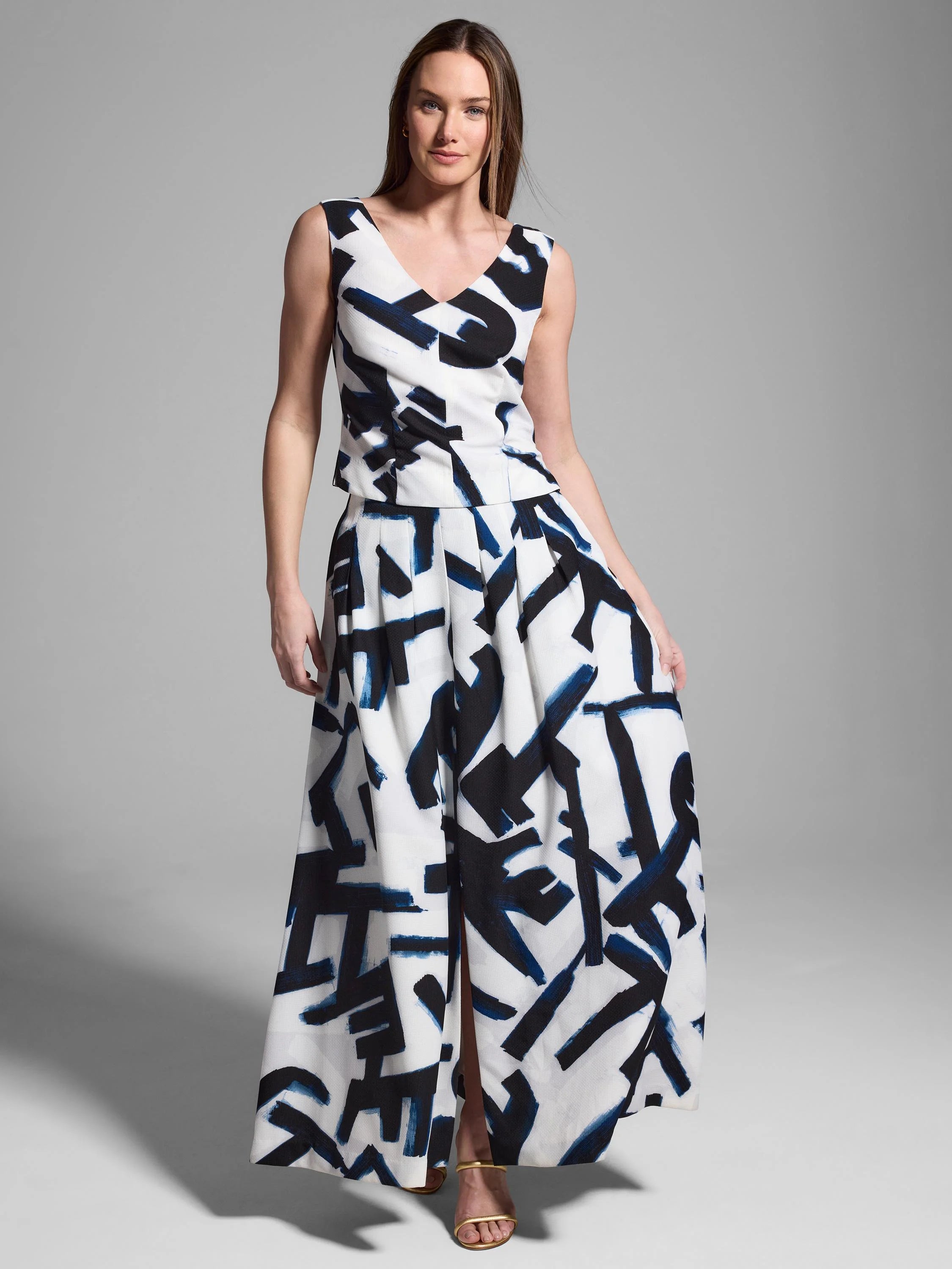 White sleeveless top and maxi skirt with a navy and black abstract print.  The skirt has a center slit.