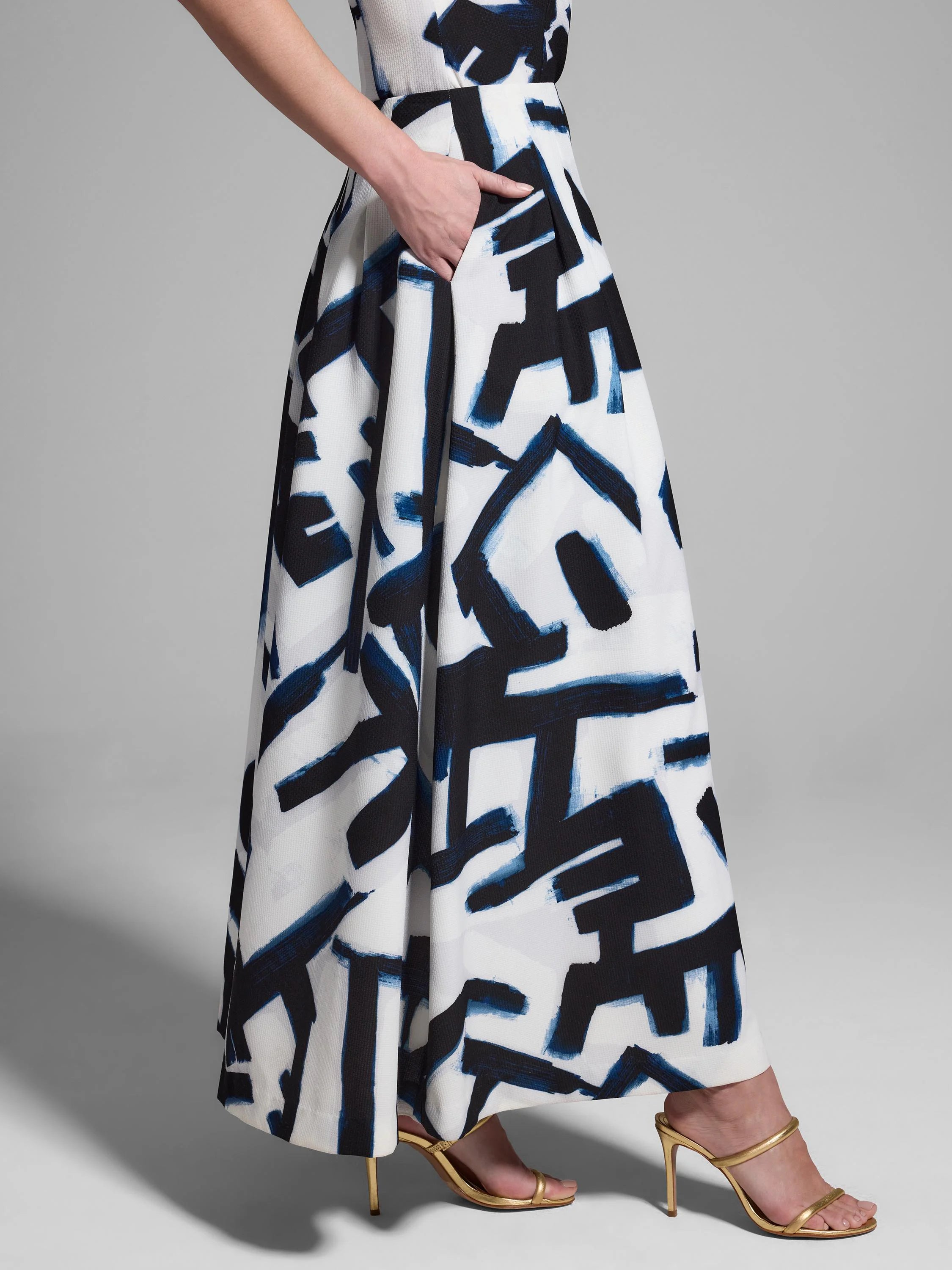 White midi skirt with a navy and black abstract print.  Features pockets.
