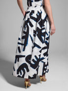 White pleated maxi skirt with a dark blue and black abstract print.