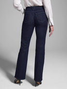 Dark wash bootcut jeans shown from the back.  Features include belt loops and back pockets.