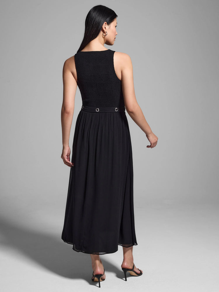 Black sleeveless midi dress with smocked bodice and a waistband featuring metal eyelets. A-line skirt.