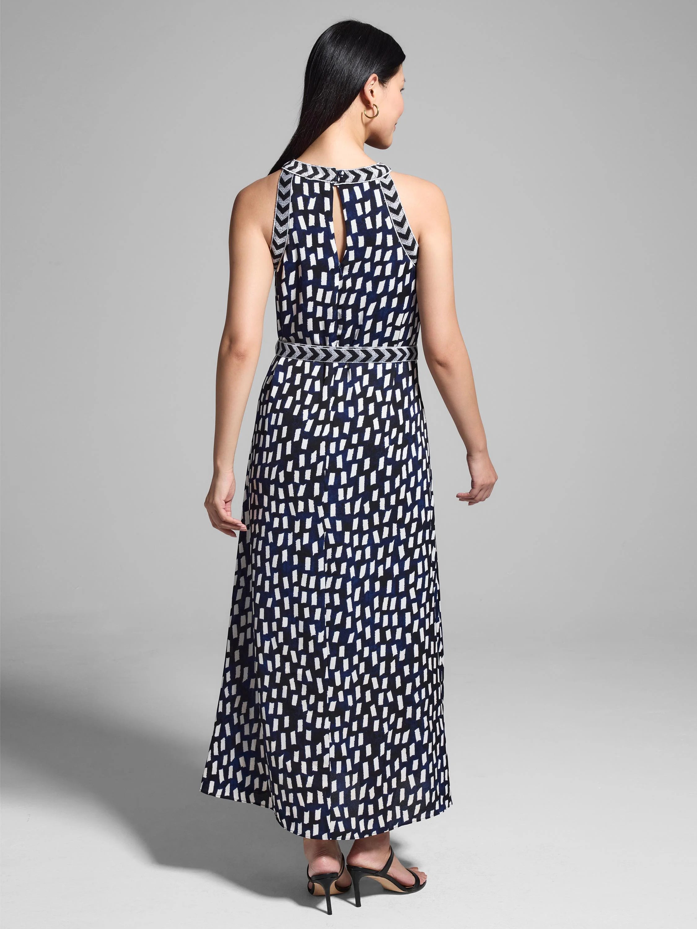 Black, white, and navy blue maxi dress.  Halter neck, keyhole back, and an abstract print.  Features a thin, patterned belt.