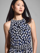 Sleeveless midi dress; navy, white, & gray geometric print;  neckline & waist band feature chevron pattern.