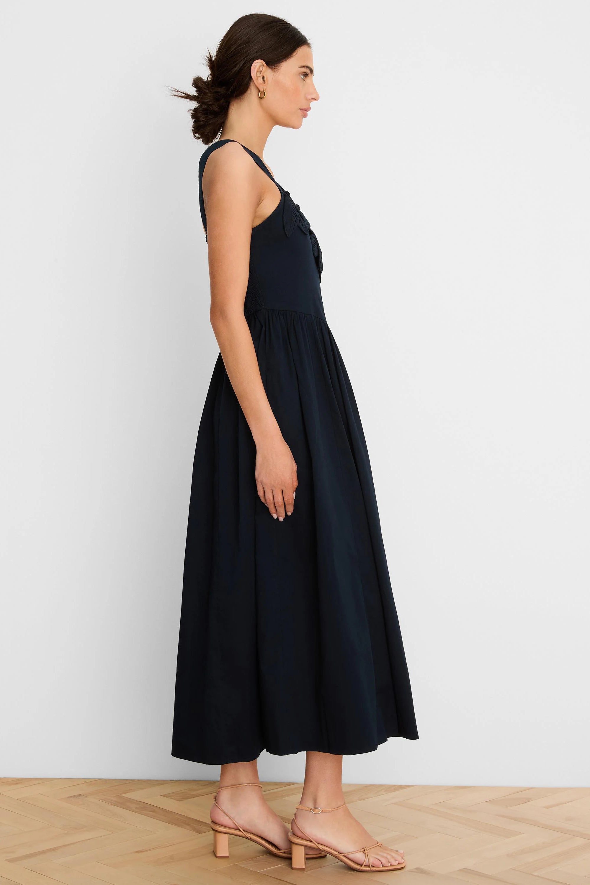 Navy strappy dress with applique bodice and a flowing midi skirt.
