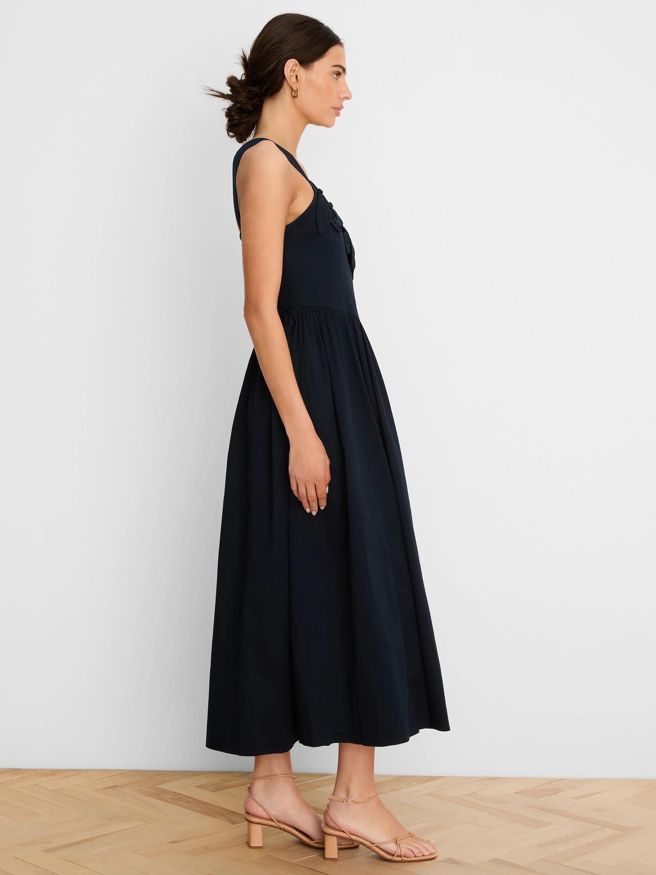 Navy strappy dress with applique bodice and a flowing midi skirt.
