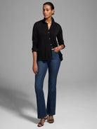 Black long-sleeve pleated sweater with button front.