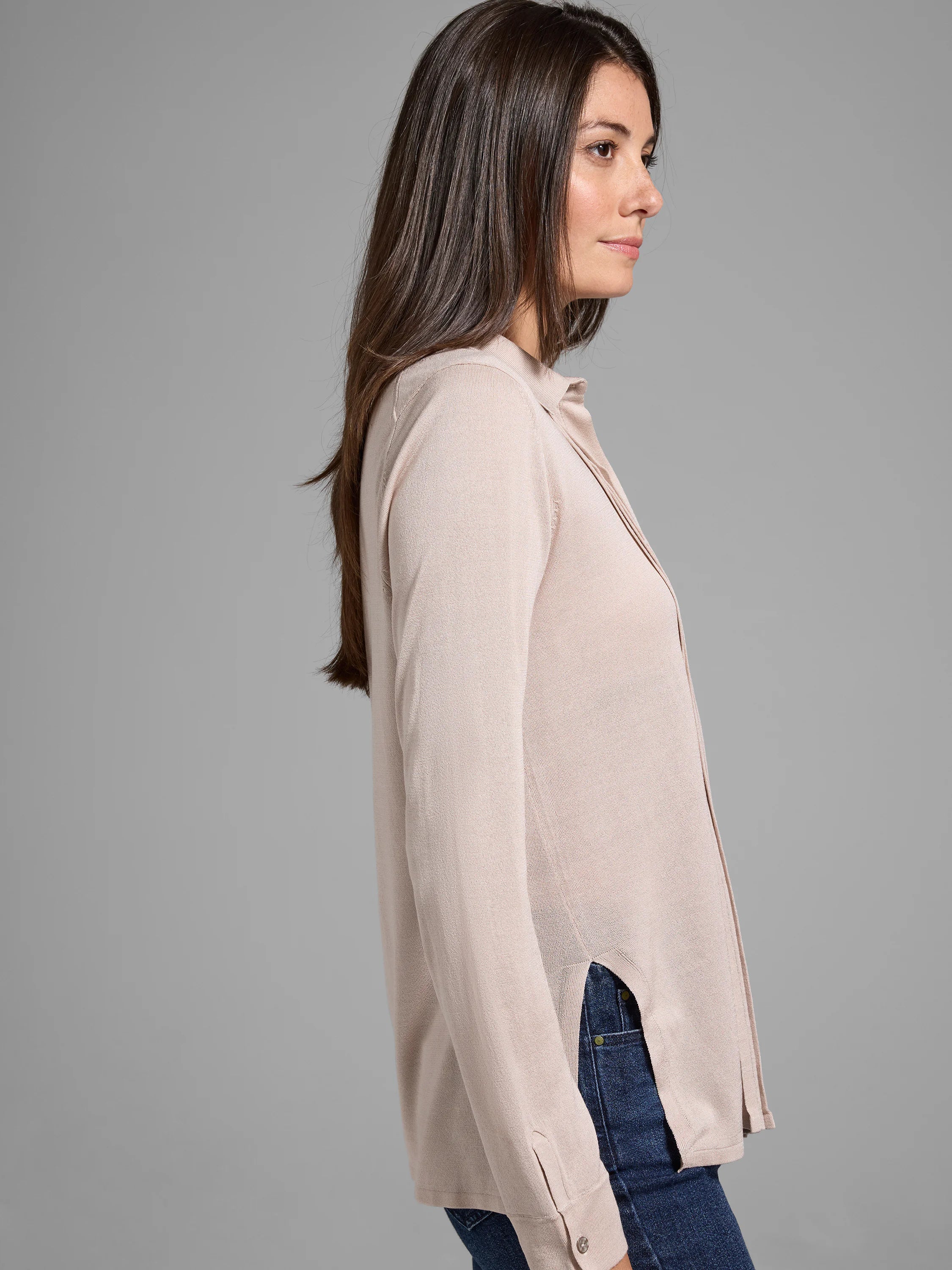Beige long-sleeve collared sweater with side slits.  The sweater is shown on a model.