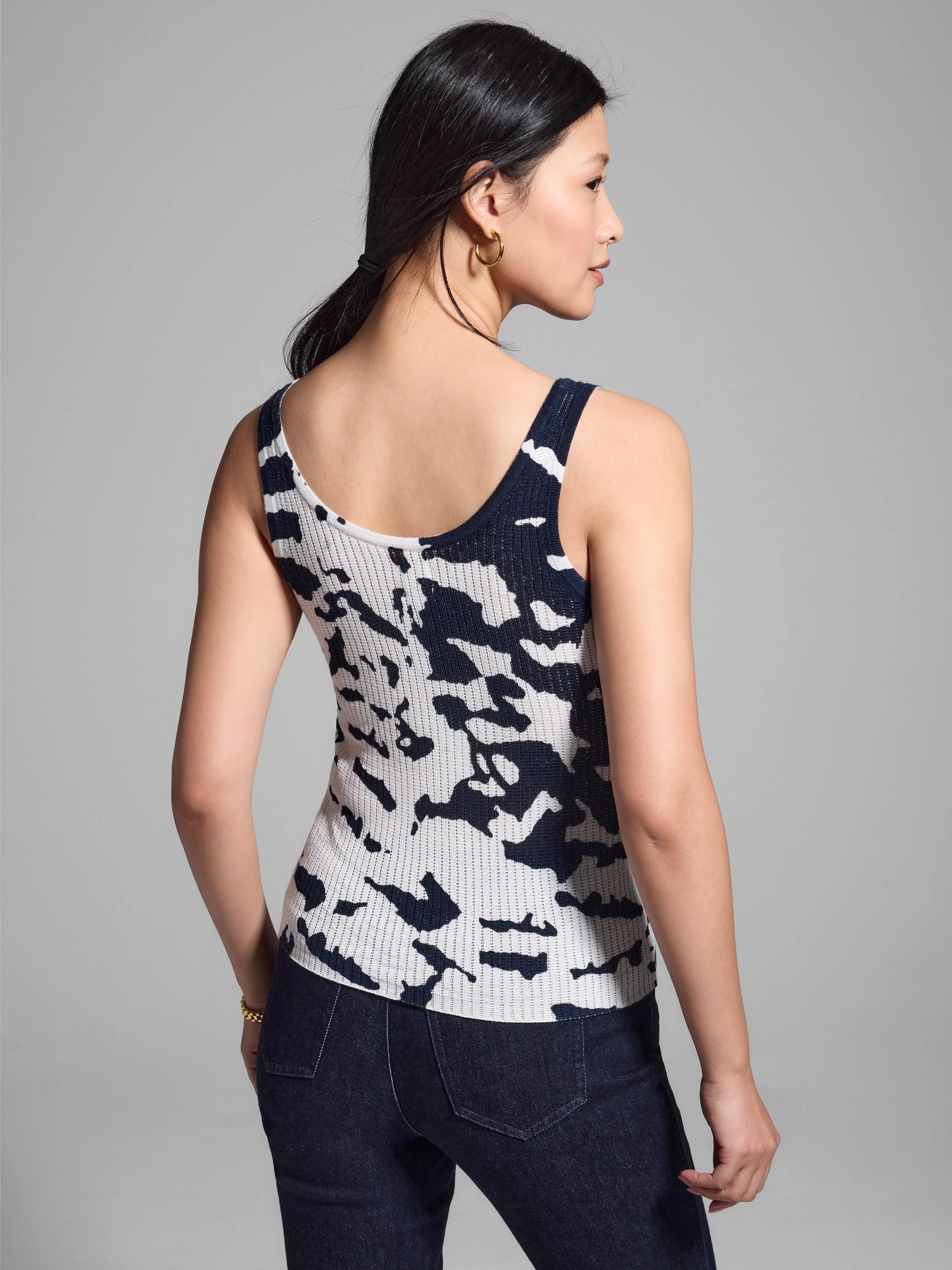 Here's alt text for the image, following the guidelines:
"Back view of ribbed tank top; off-white with dark navy...