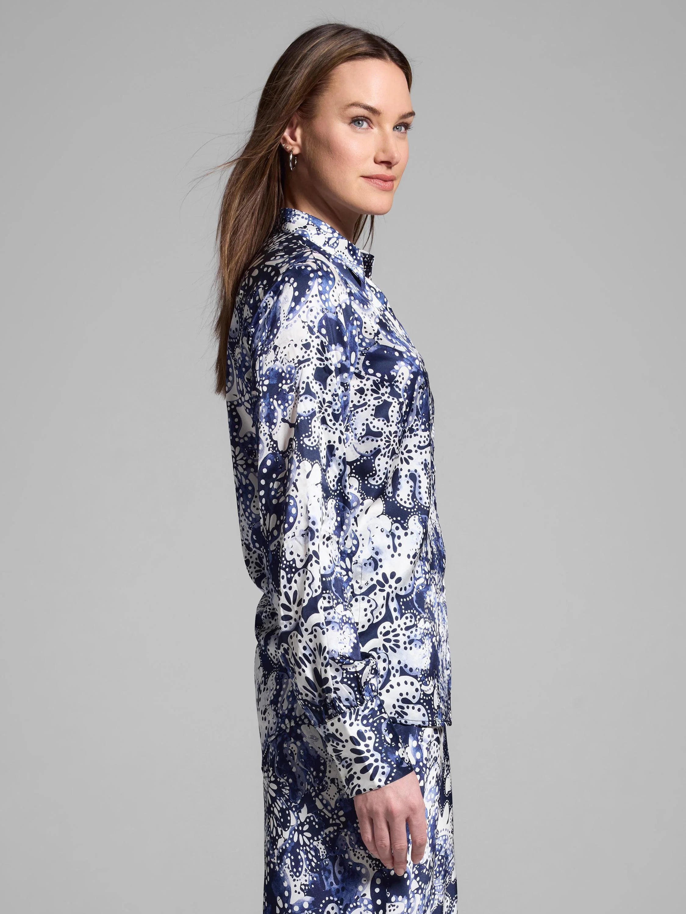 Silk shirt, long sleeves, collared.  Off-white background with navy blue floral print; scattered dots.