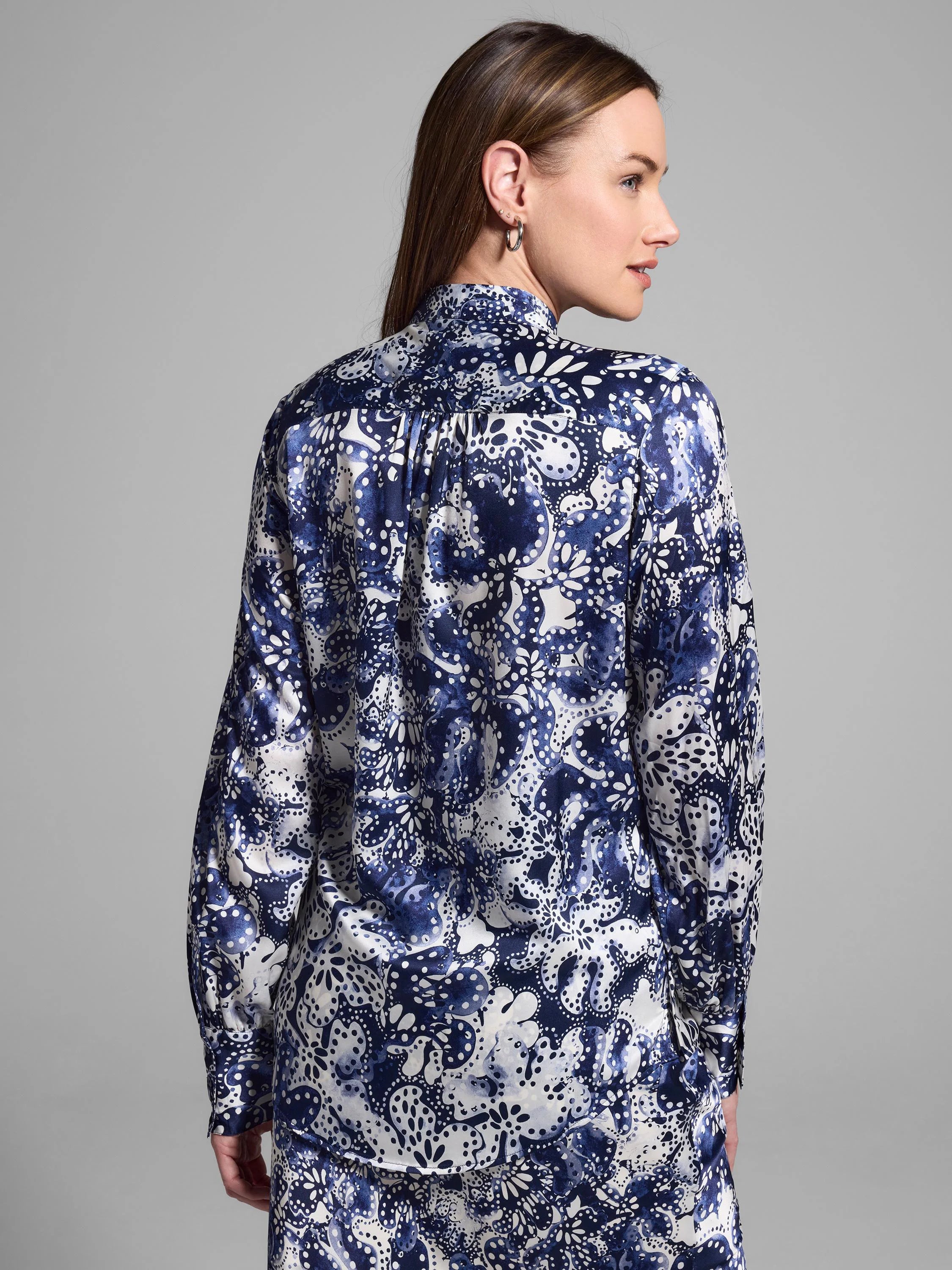 Silk shirt; navy blue and white floral pattern, long sleeves.