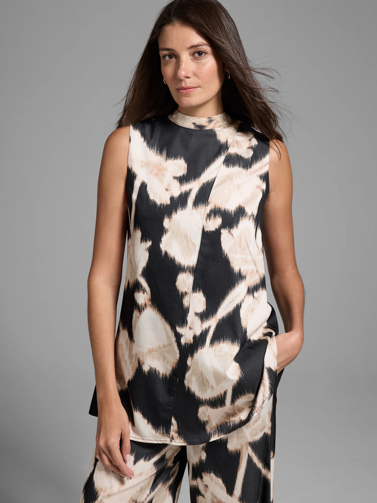 Black sleeveless top with beige floral print. High neck, A-line shape.