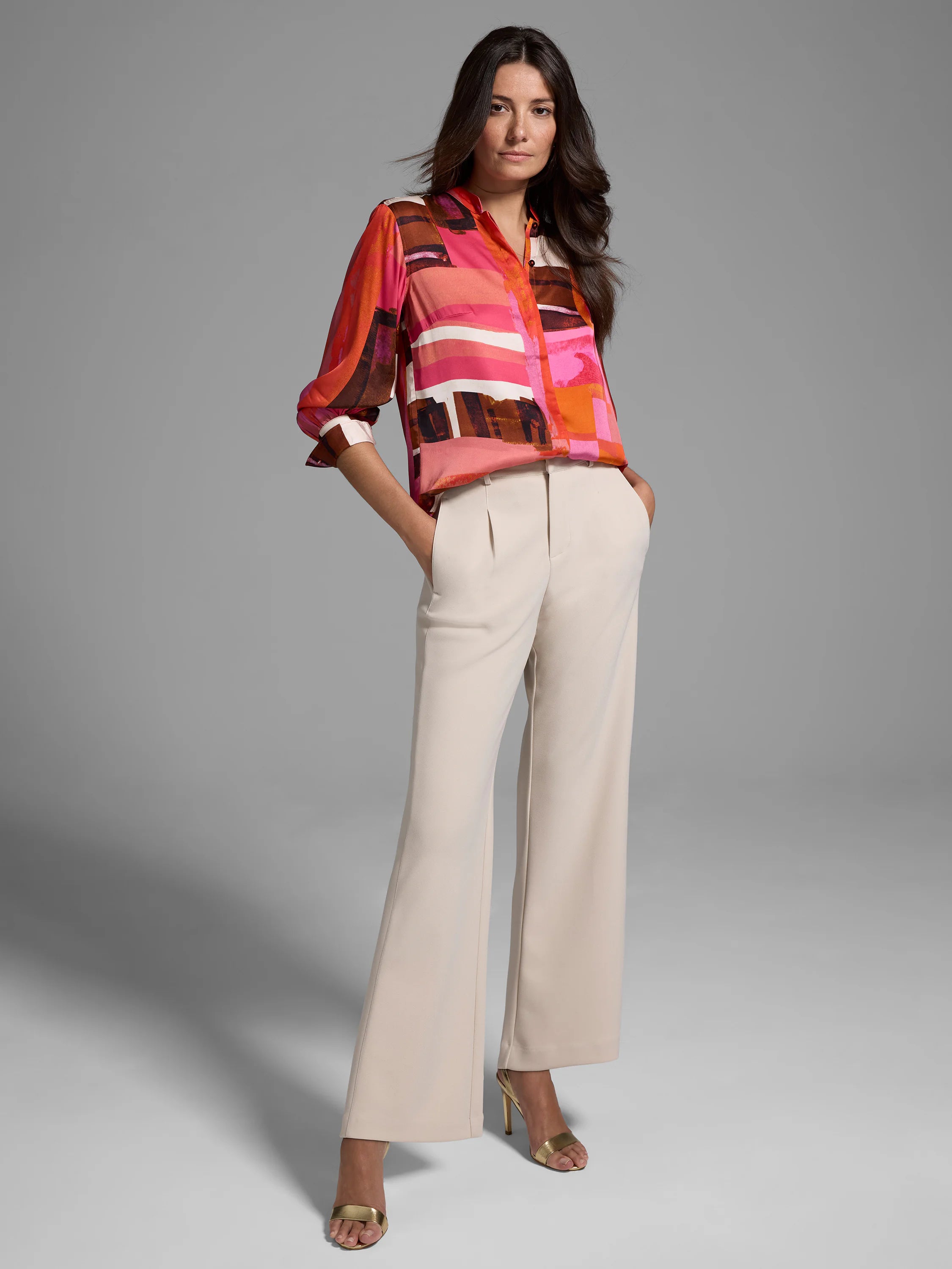 Glossy blouse with pink, orange, brown abstract print. Long sleeves, collared.