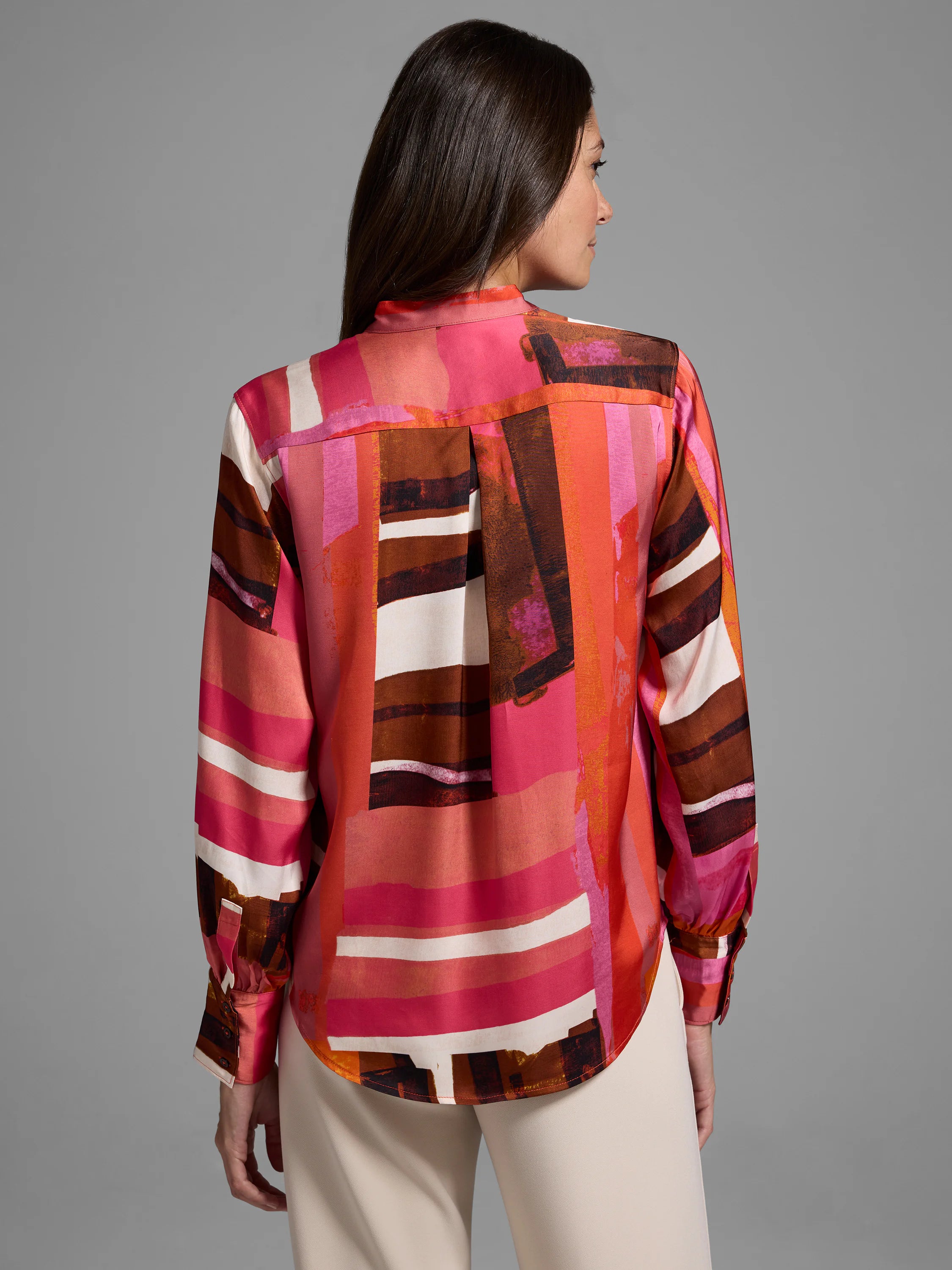 Abstract print blouse; pink, orange, brown, & white horizontal stripes. Long sleeves, buttoned cuffs.