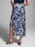 Silk midi skirt in white and navy blue with a floral print and a side slit.