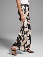 Wide-leg pants, black and beige floral print.  High-waisted, with a belt.
