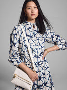 Off-white shirt dress with navy blue and light blue fractured line pattern.  Long sleeves, belted waist.