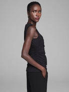 Black sleeveless jersey tank featuring vertical side ruching.