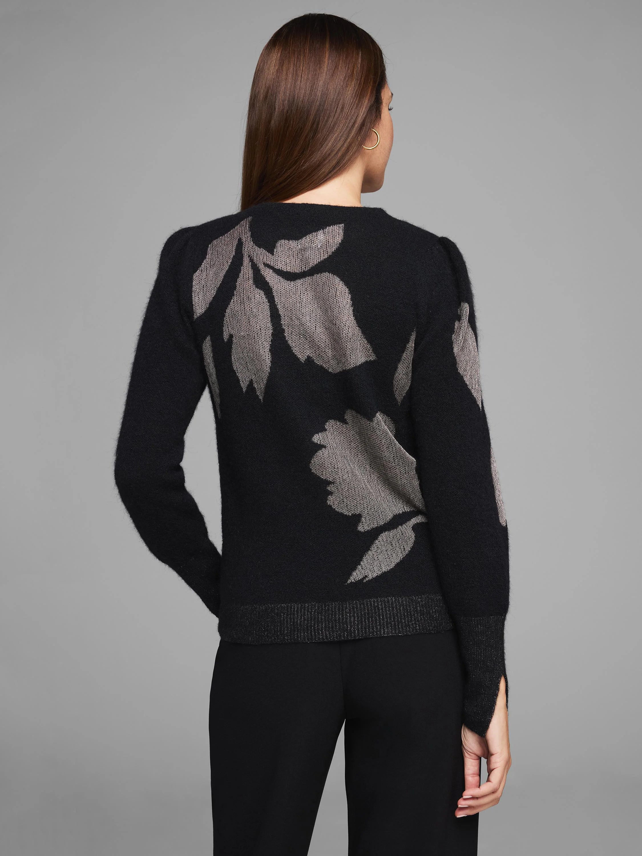 Black knit sweater with metallic grey floral pattern on back & sleeves. Ribbed hem, slit cuffs.
