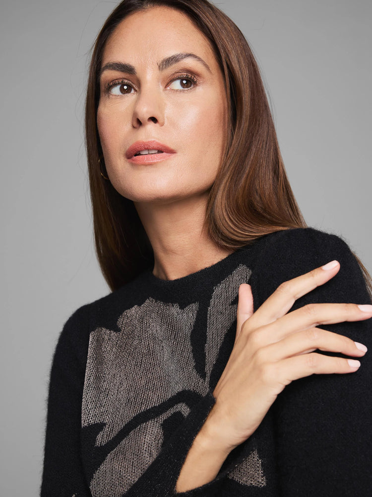 Black sweater with a shimmering gold lace knit floral pattern.