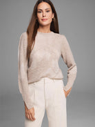 Beige knit sweater with faint floral pattern, long sleeves, and slit cuffs.