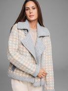 Houndstooth knit jacket in cream, tan, and grey. Features fuzzy light grey collar, lapels, and asymmetric zipper.
