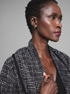 Black and white textured jacket with blue flecks and a black trim detail.