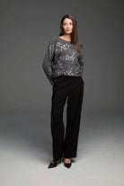 Dark grey sweater with a silver sequin abstract pattern.