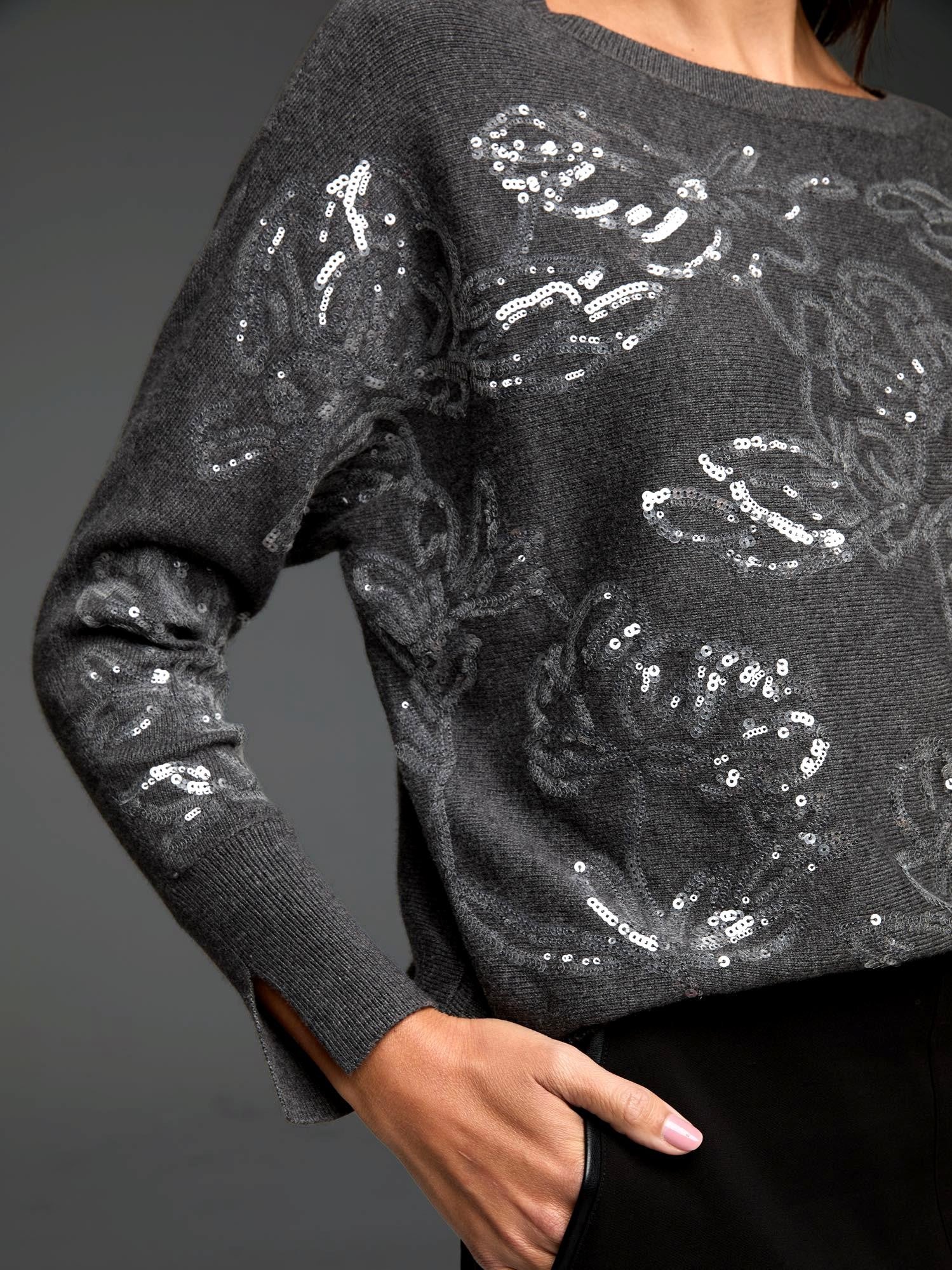 Dark gray sweater with silver sequin floral pattern. Ribbed cuffs with slits.
