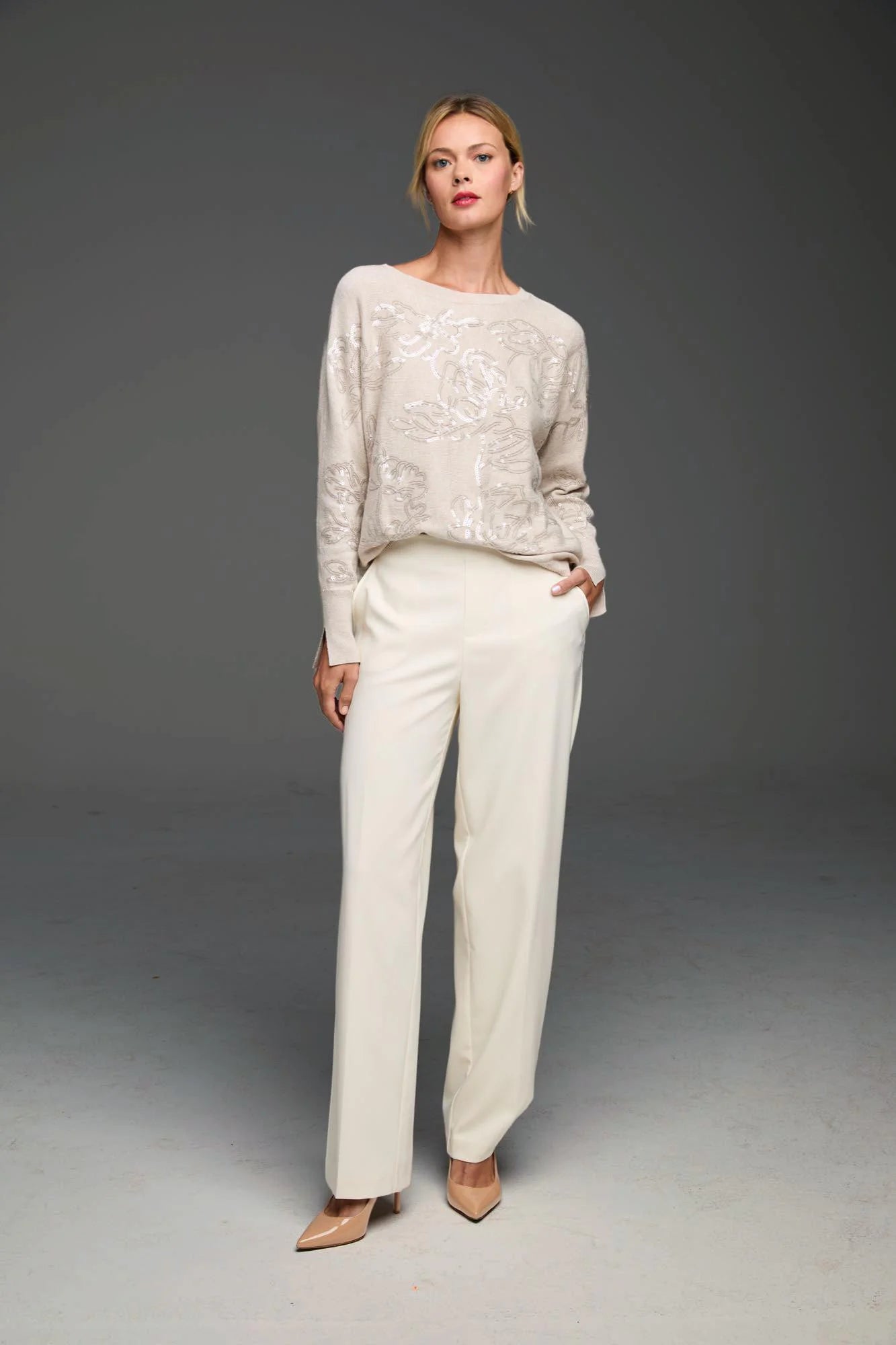 Light beige relaxed sweater with all-over sequin pattern.