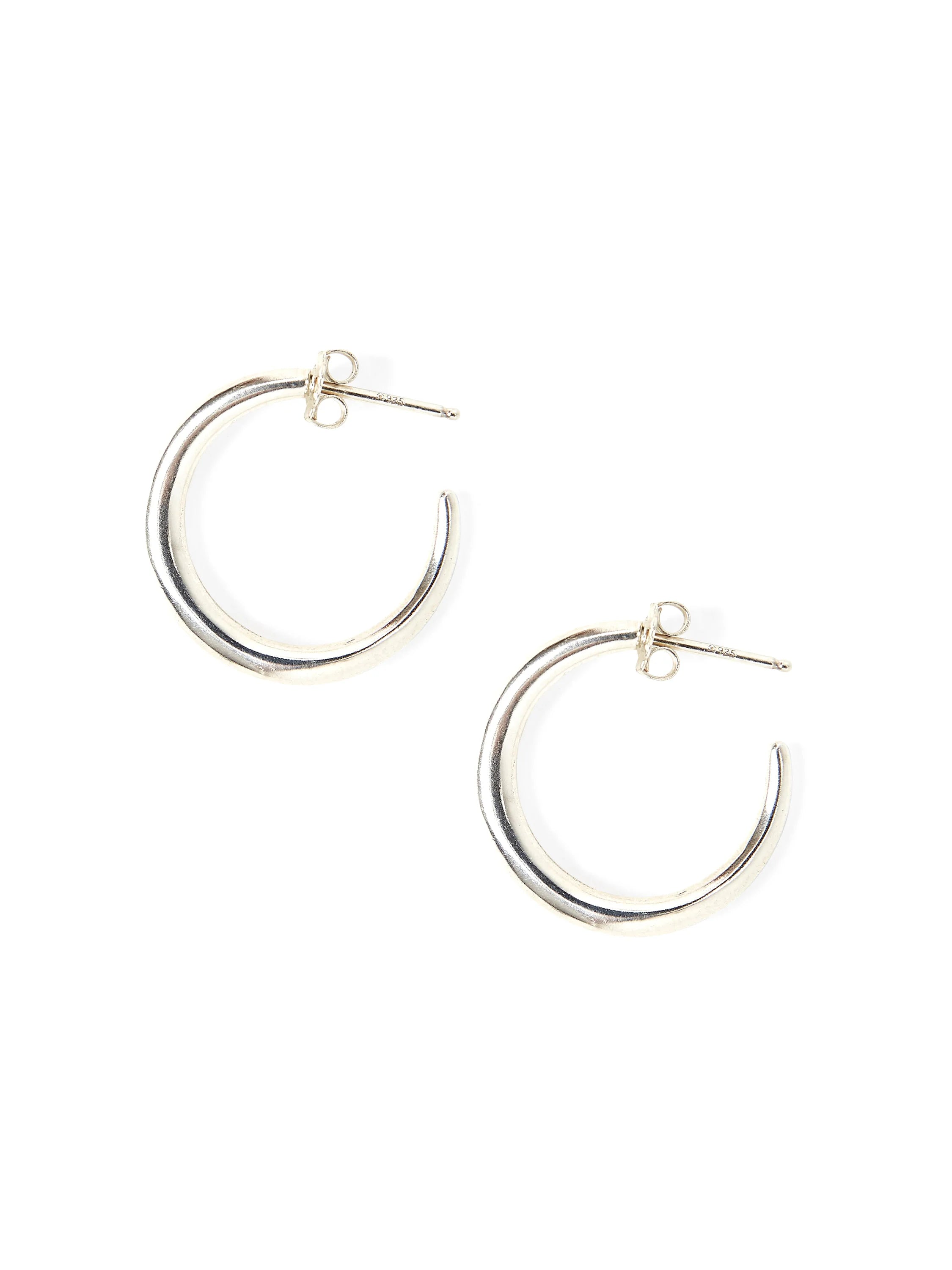 Pair of silver-toned hoop earrings, C-shaped with a post-back closure. Smooth, polished metal.