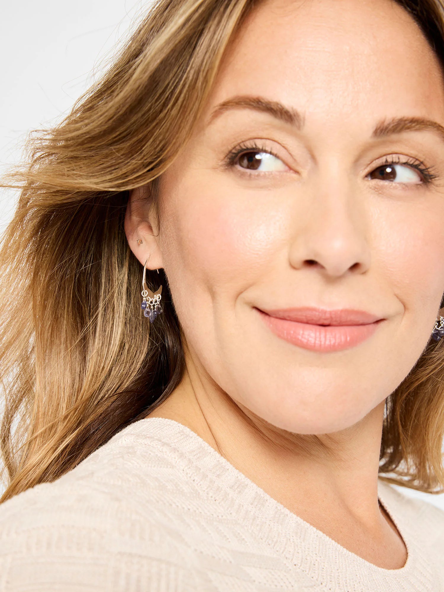 Gold-tone crescent earrings with four dangling dark blue iolite beads.