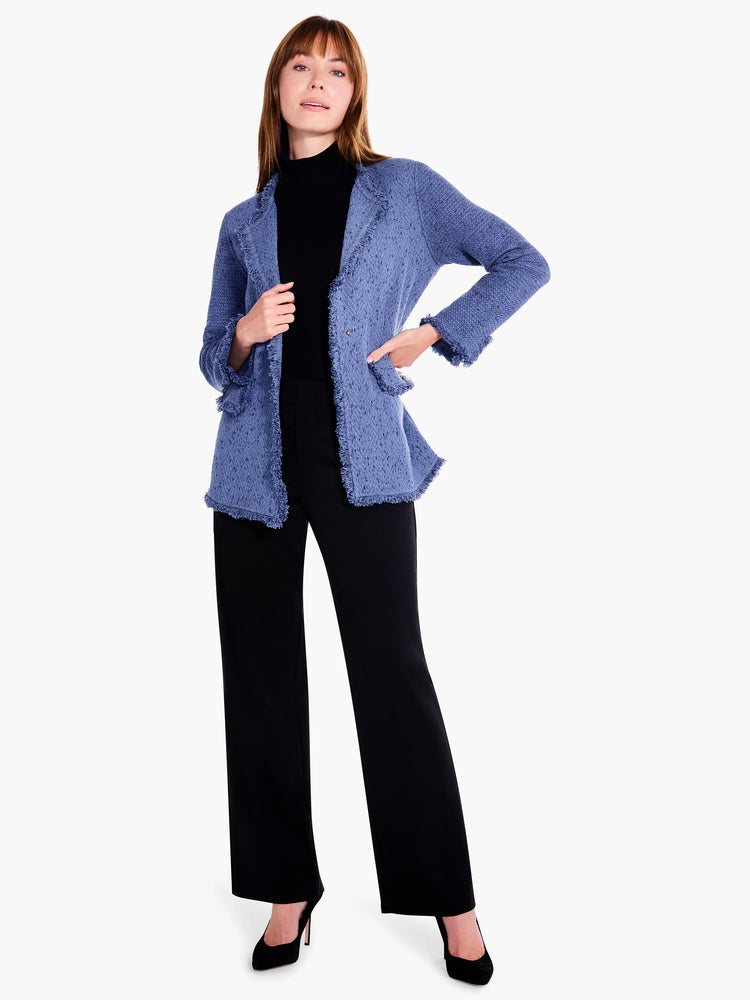 Blue knit blazer with fringe trim. Single button closure. Model wears black pants & shoes.