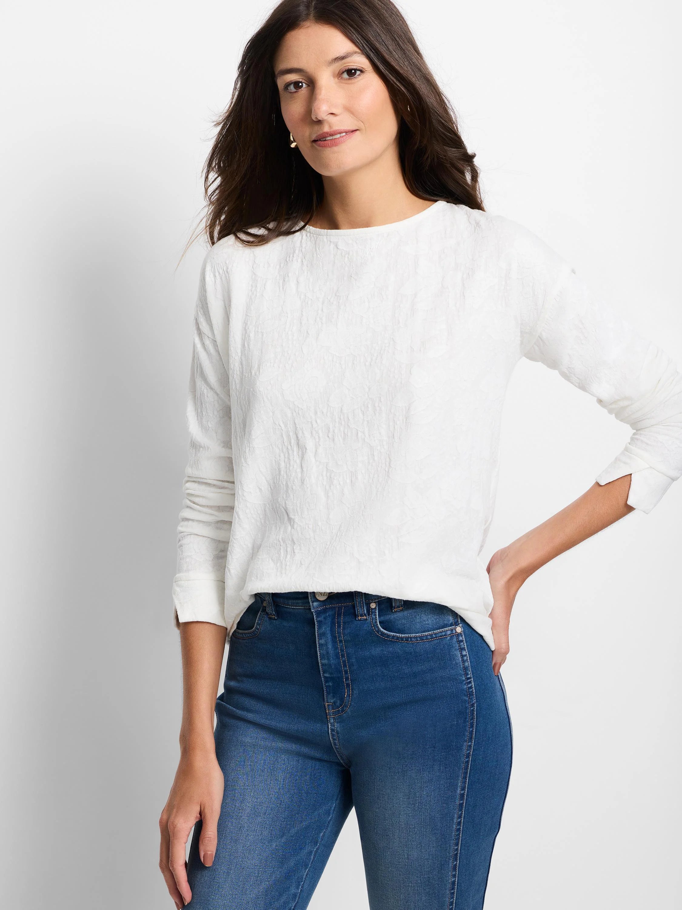 White long-sleeve tee with a round neck and subtle, all-over embossed lace knit texture.