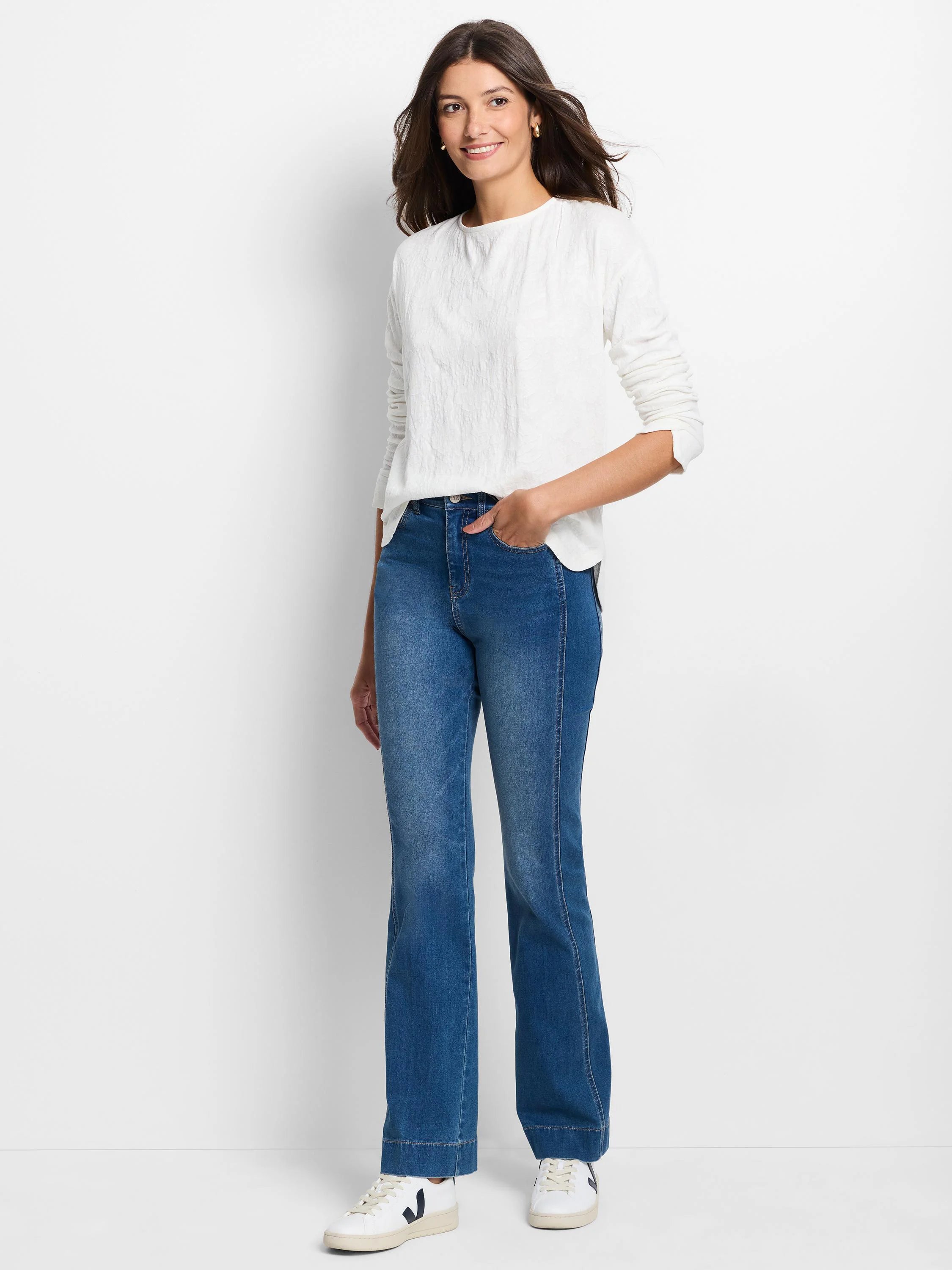 Off-white, loose-fit, long-sleeve tee with a textured knit pattern and round neck.