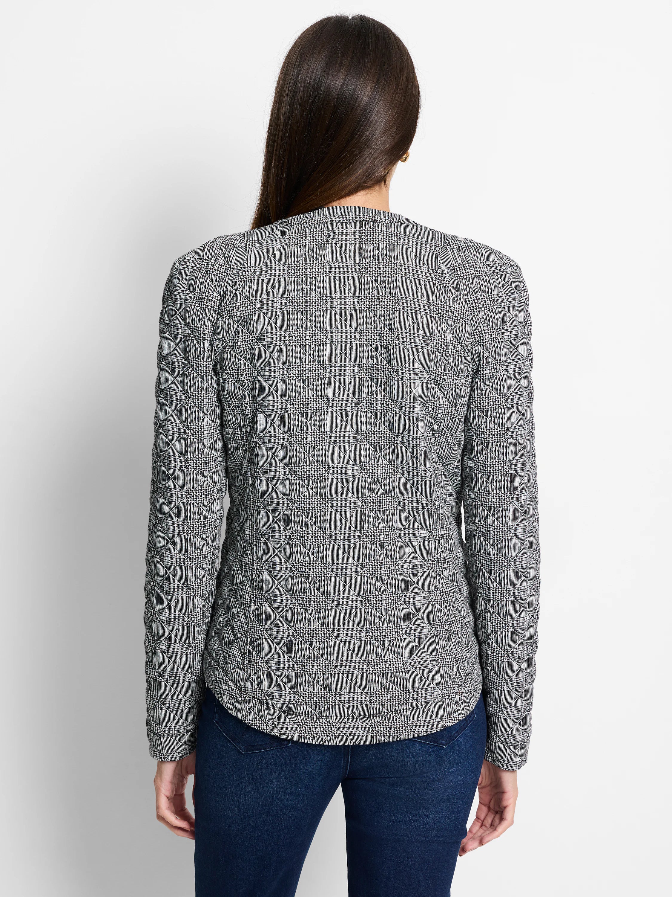 Black & white houndstooth plaid jacket, quilted with diamond stitching, seen from the back.