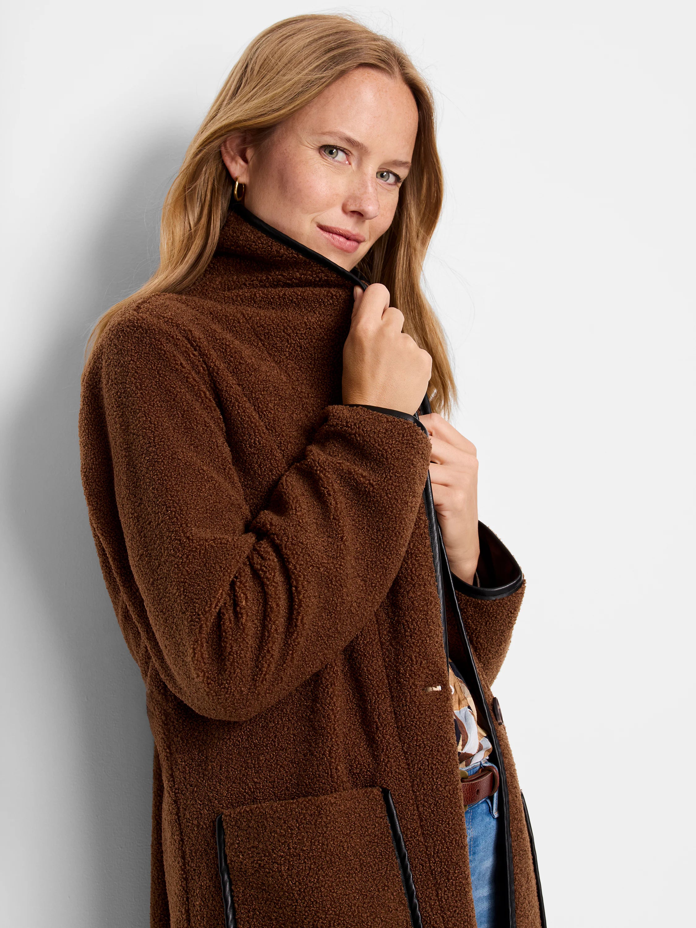 Brown teddy coat with black trim on the collar, front edge, and pockets.