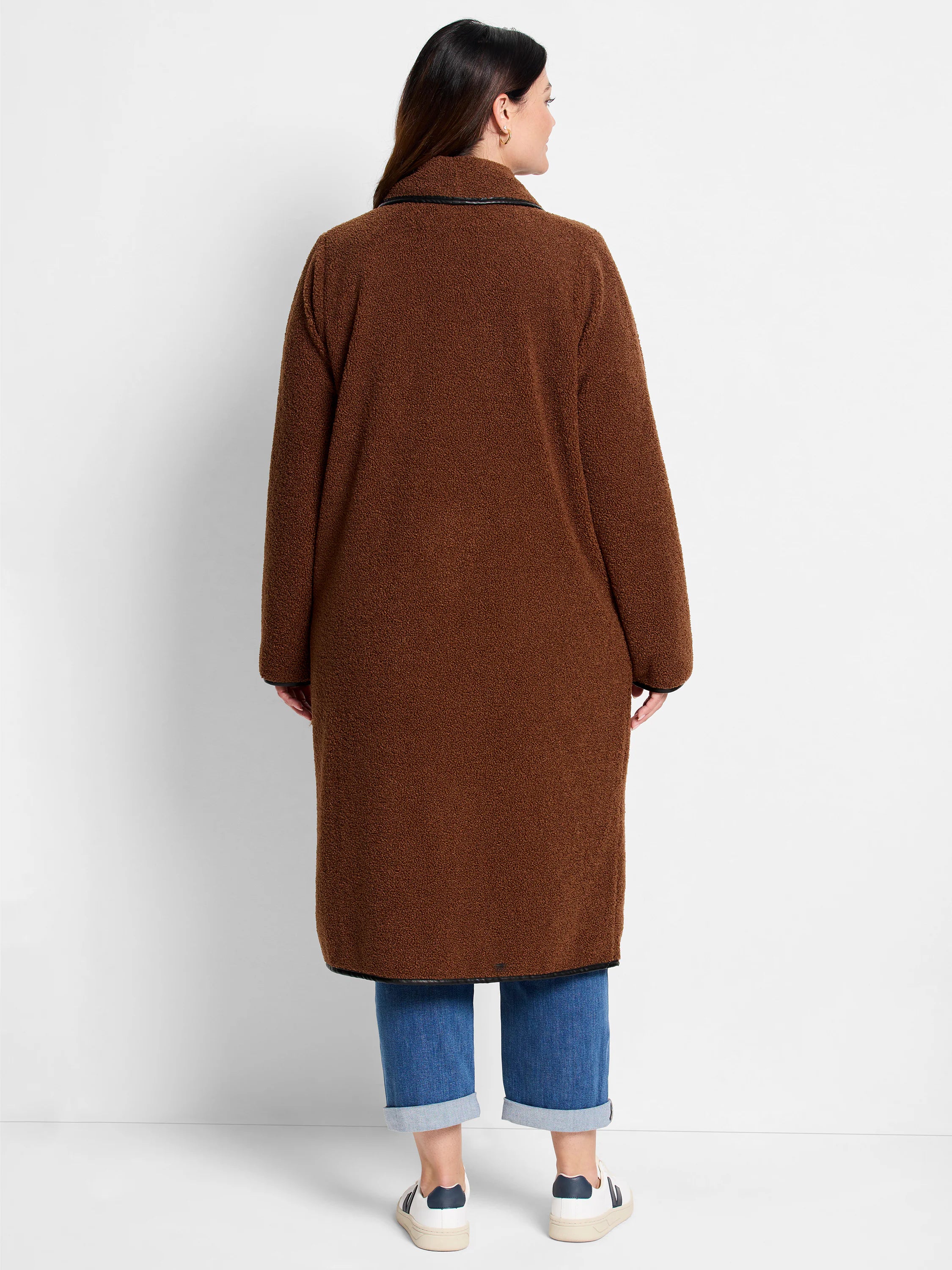 Brown, long teddy coat with fluffy texture and black trim details.