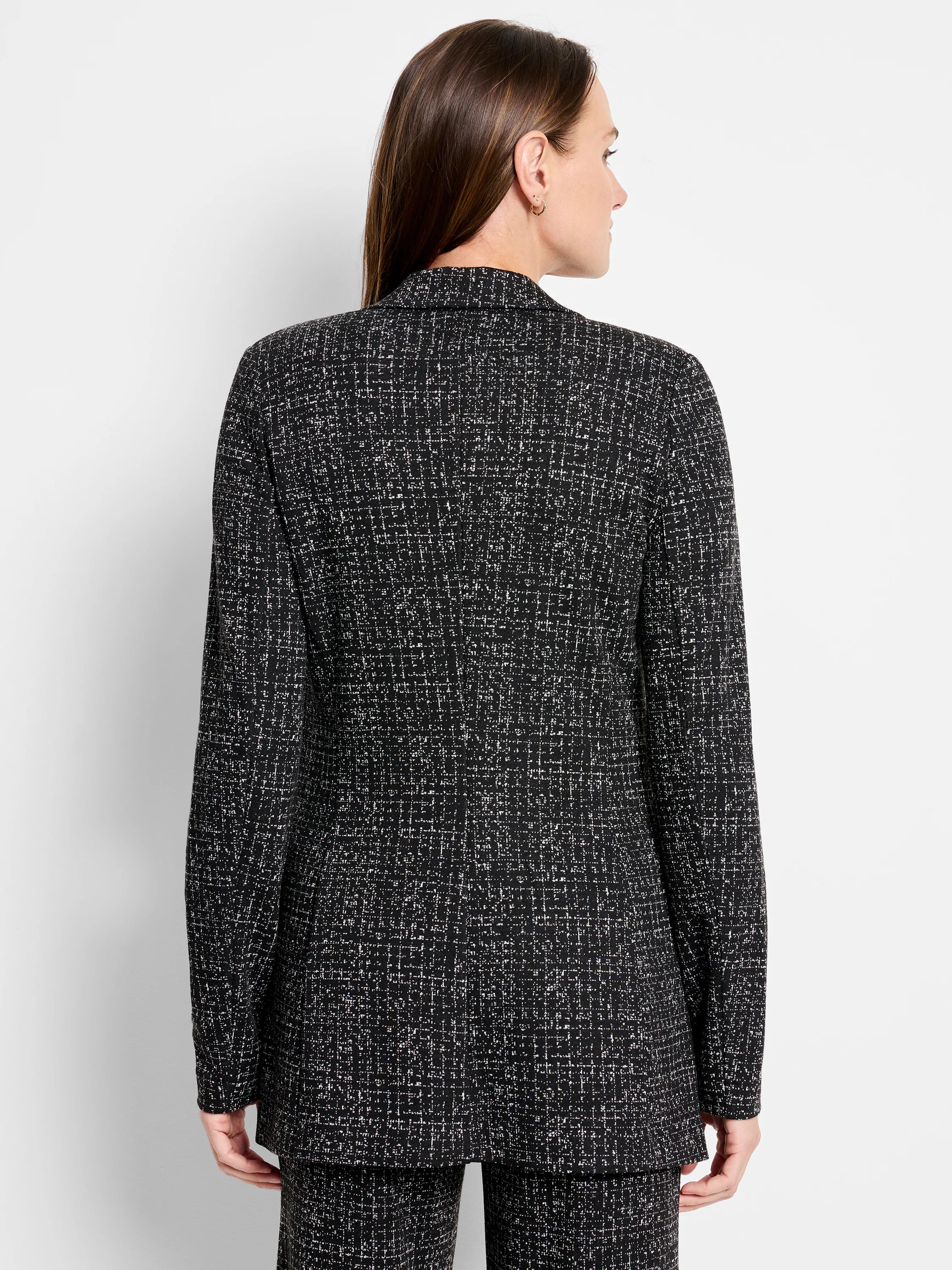 Black and white speckled dotty grid knit jacket with long sleeves, shown from the back.