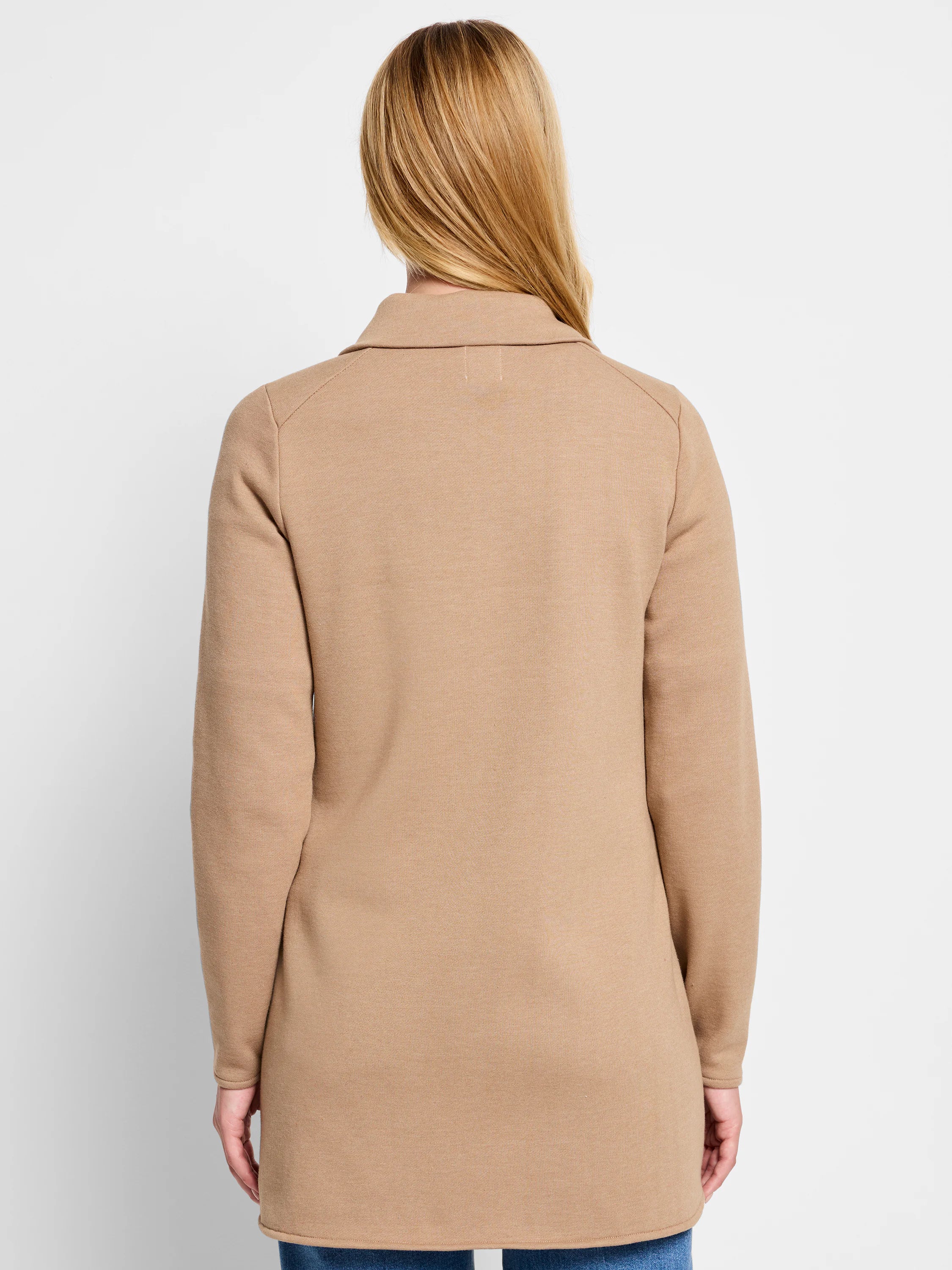 Tan jacket, seen from back. Features long raglan sleeves, a collar, knit texture, and mid-thigh length.