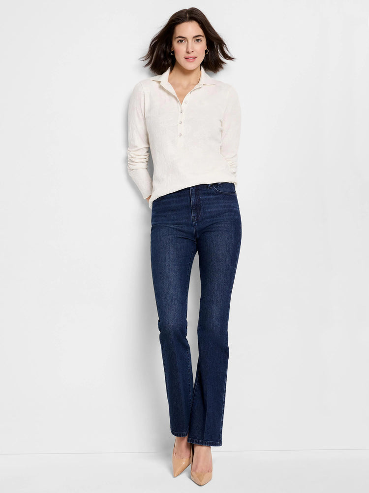 Off-white lace knit collared top with long sleeves and partial button placket, worn by a model.