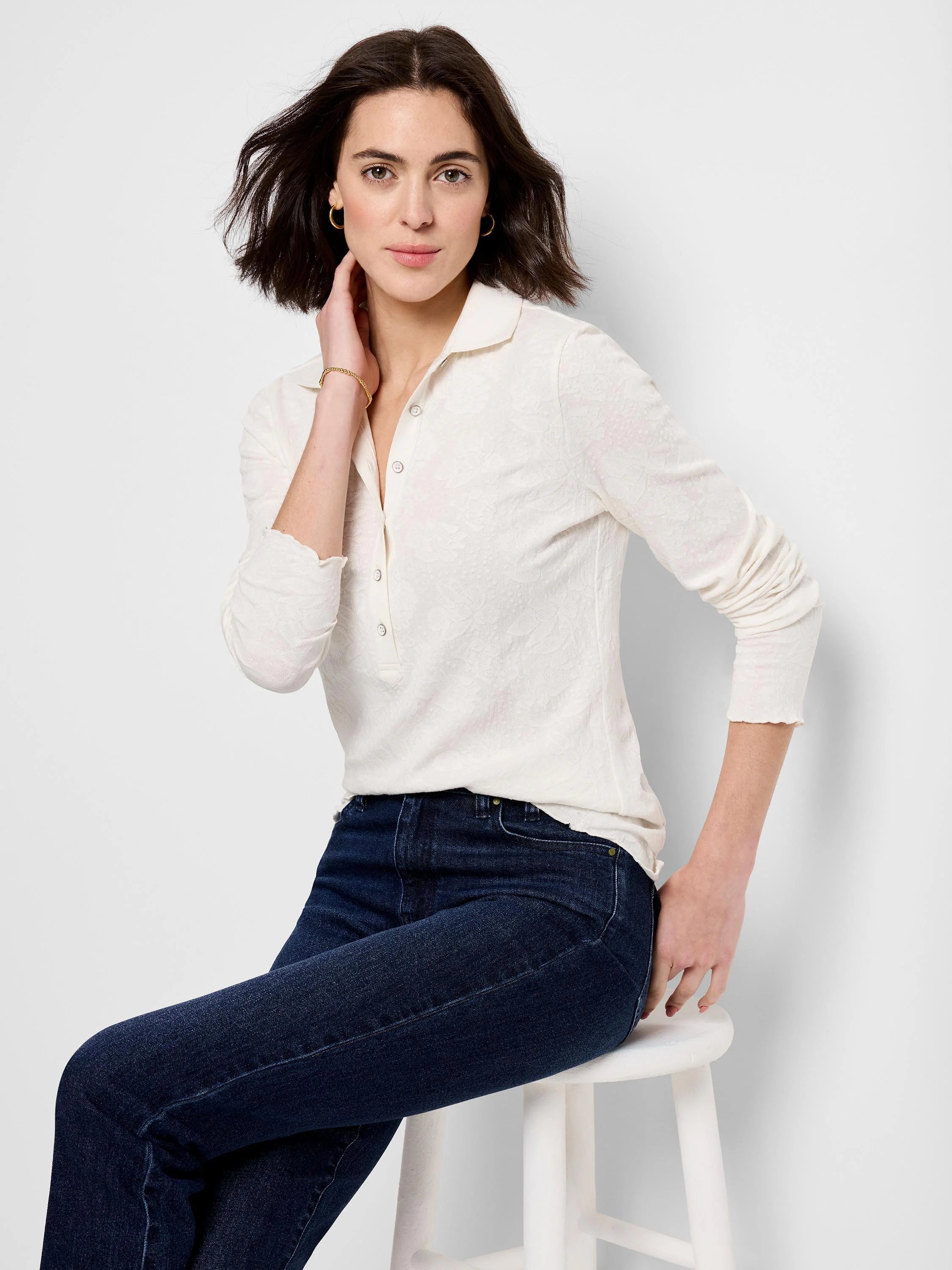 Cream lace knit collared henley top with long sleeves and ruffled cuffs.