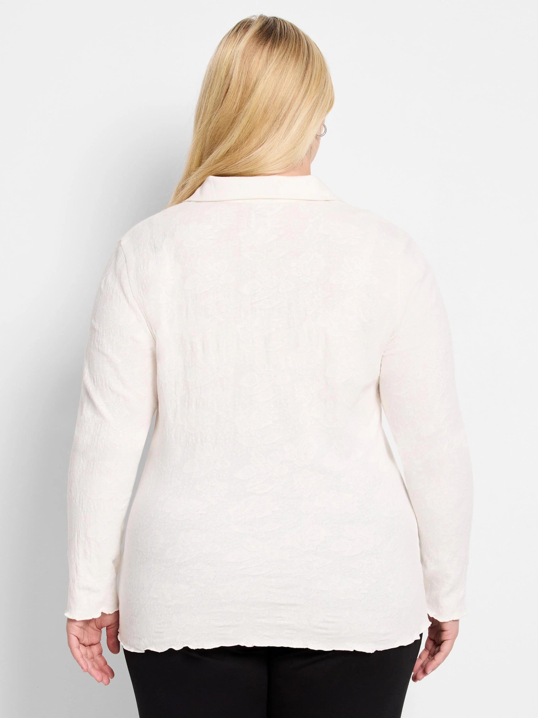 Off-white lace knit collared top, back view, with long sleeves, scalloped cuffs and hem.