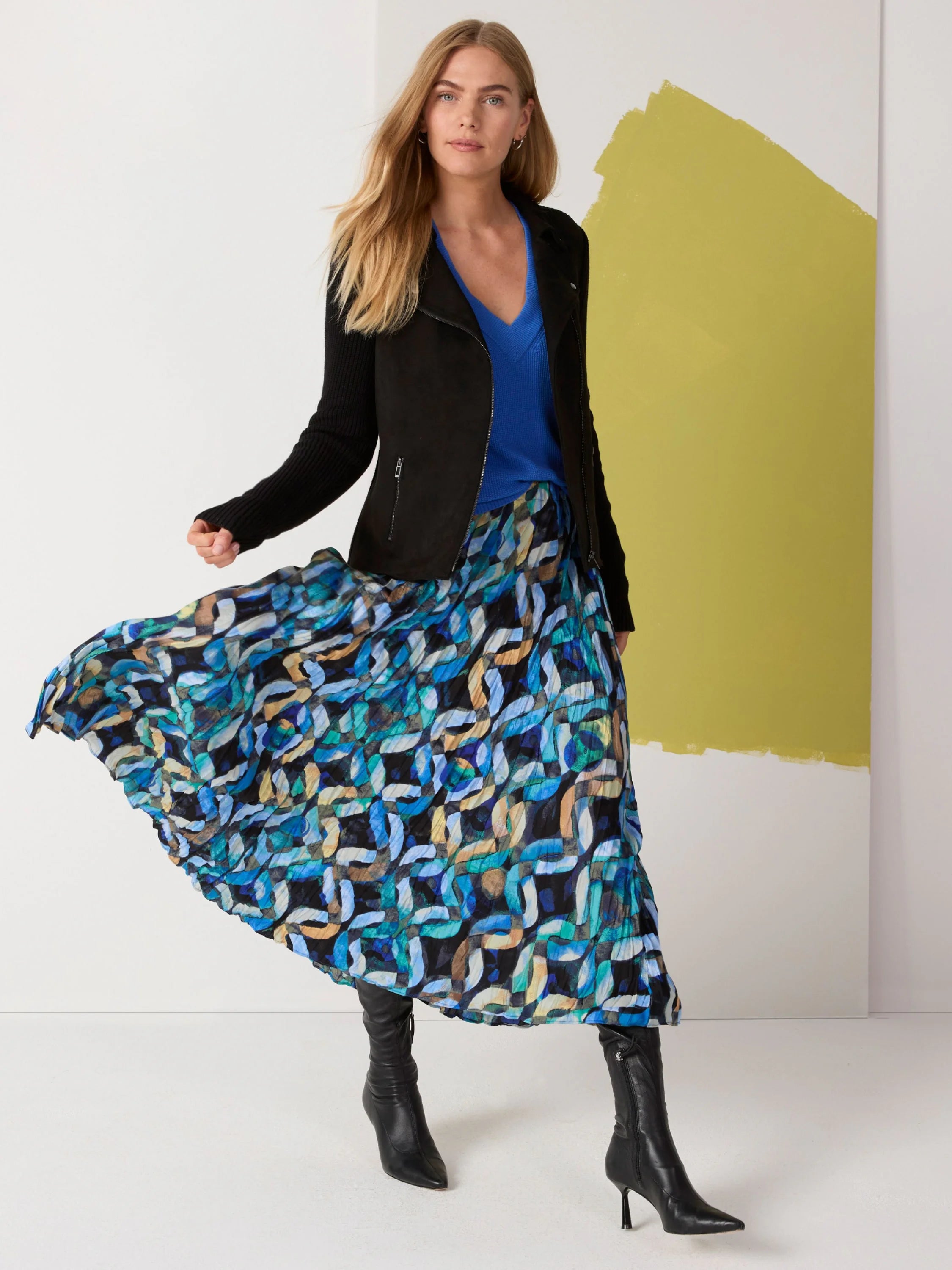 Black moto jacket with a faux suede body, ribbed knit sleeves, and zipper details.