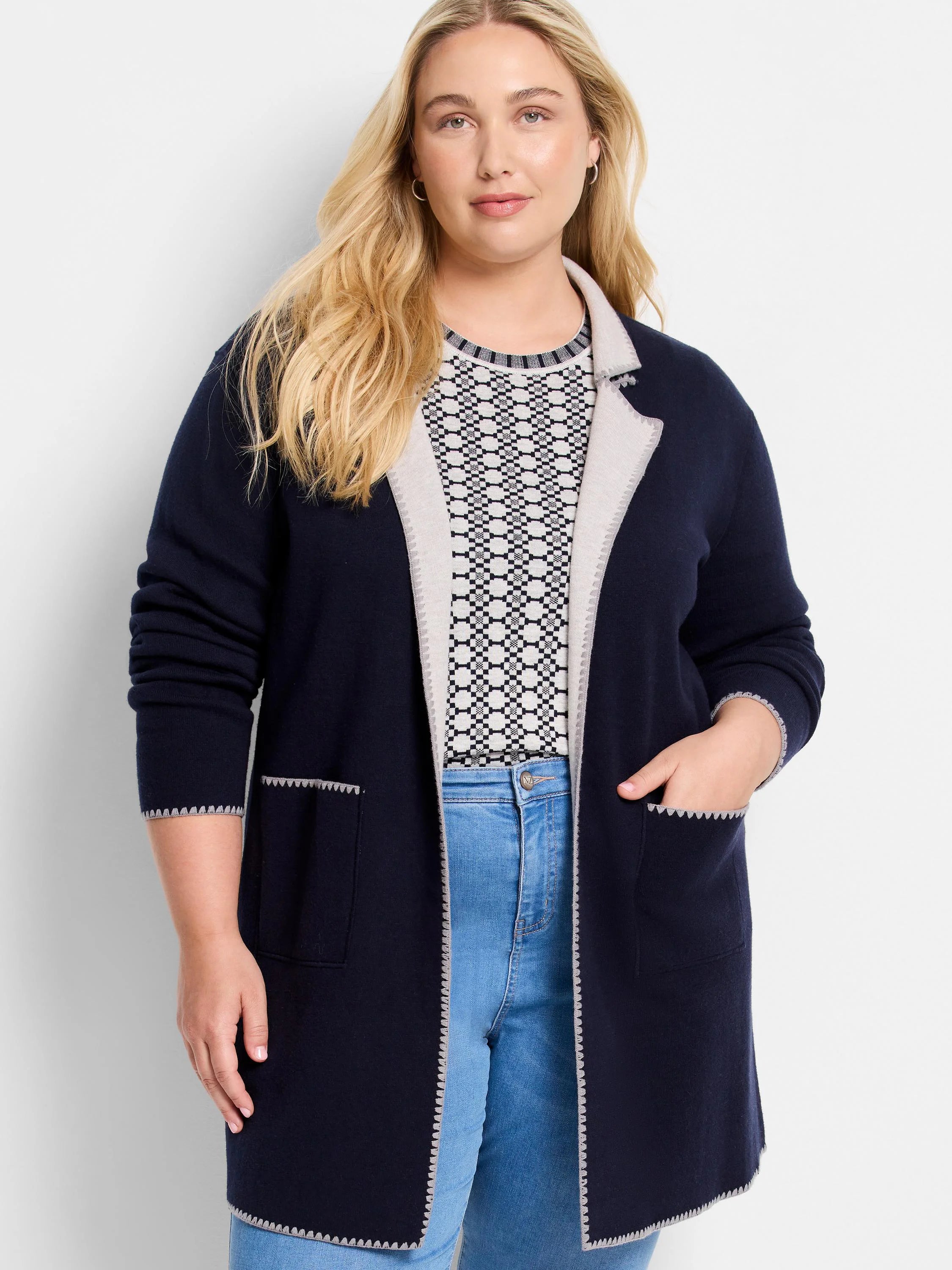 Dark blue reversible knit jacket with light gray lapels. Features scalloped trim on edges, cuffs, and patch pockets.